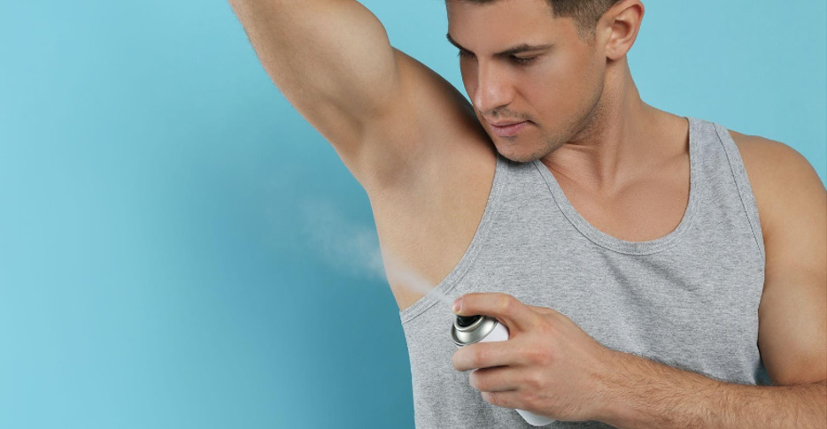 Men spraying deodorant